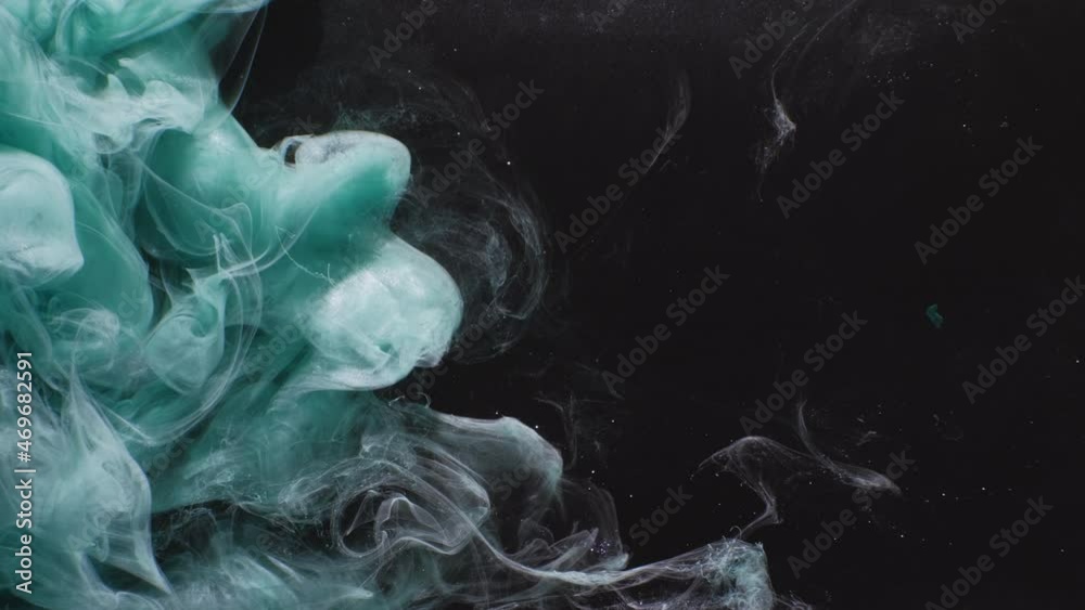 Underwater splash. Ink water mix. Abyss wave. Teal blue color glitter vapor cloud animation on black abstract art transition layer effect background.