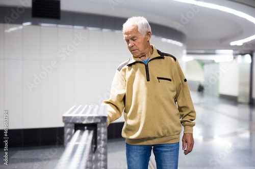 Elderly passenger pays for a metro ride using mobile phone