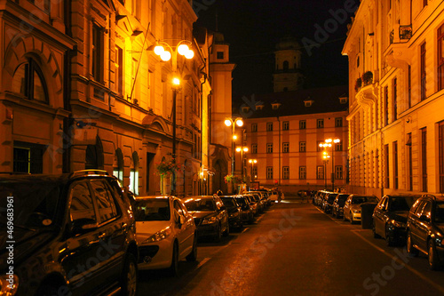 Bright lanterns on the streets of the city in the evening. Czech.