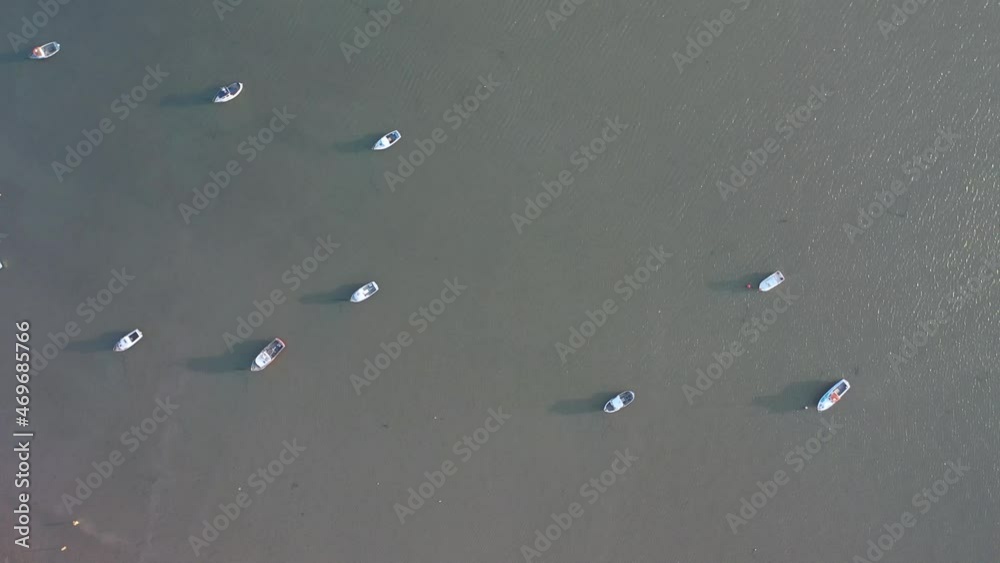 Small boats on calm water surface, moored on water in evening Small boats on calm water surface, moored on water in evening