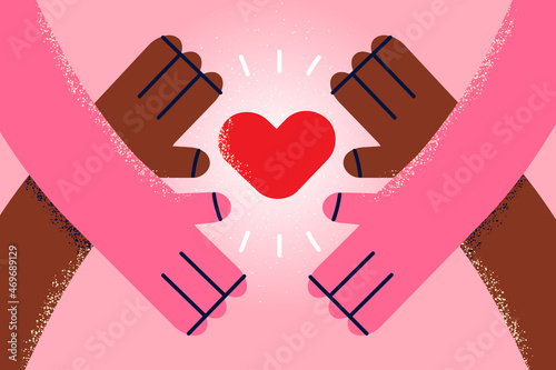 Diverse people hands hold heart show love