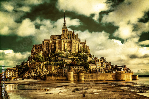 Picturesque view at the Mont Saint Michel. Le Mont Saint Michel island, one of the most visited historical sites in France. Old style illustration.