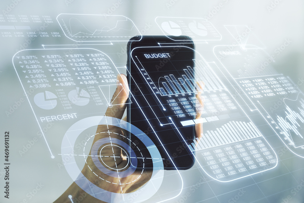 Double exposure of abstract creative statistics data hologram and hand with cellphone on background, analytics and forecasting concept Double exposure of abstract creative statistics data hologram and hand with cellphone on background, analytics and forecasting concept