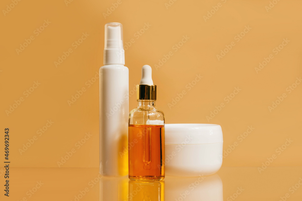 Unbranded bottles in mockup style . Tube of eye oil, daycosmetic serum, cream on beige background. Beauty background with facial cosmetic products. Spa, beauty concept. Unbranded bottles in mockup style . Tube of eye oil, daycosmetic serum, cream on beige background. Beauty background with facial cosmetic products. Spa, beauty concept.