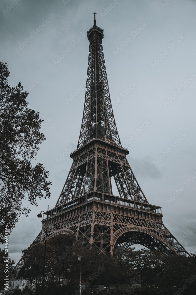 Autumn, cloudy Eiffel Tower in Paris, in the evening without lighting