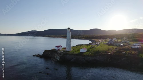 Lighthouse near Forillon National Park, Gaspe, Quebec, Canada. Shot from the ocean. photo