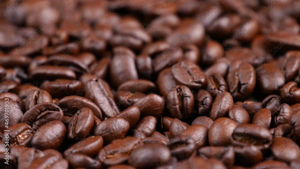 Roasted coffee beans spinning, top view. Coffee close up Roasted coffee beans spinning, top view. Coffee close up