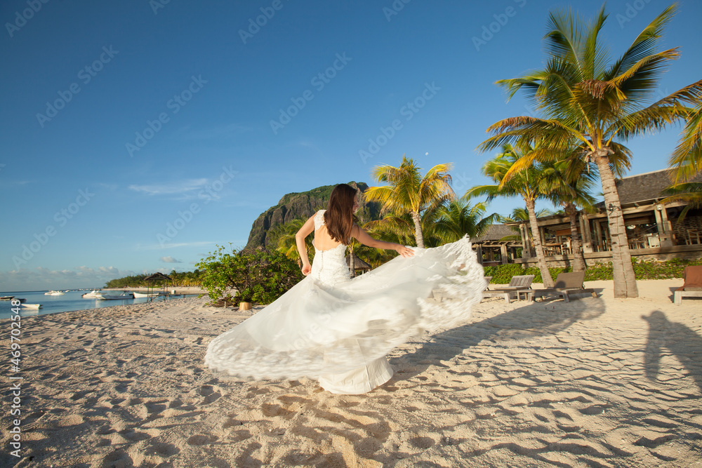 Beautiful bride in white dress on the beach Beautiful bride in white dress on the beach