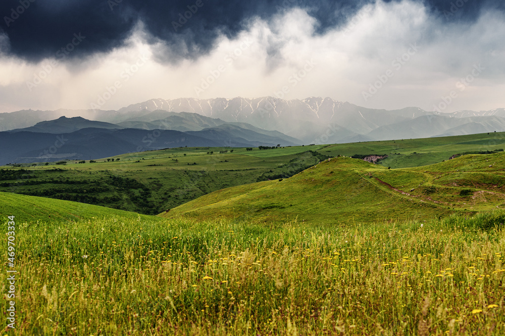 An approaching thunderstorm on an agricultural field in mountains. Mood and weather concepts