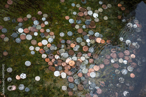 Coins in a wishing well: Hall Well, Tissington, Derbyshire, UK photo