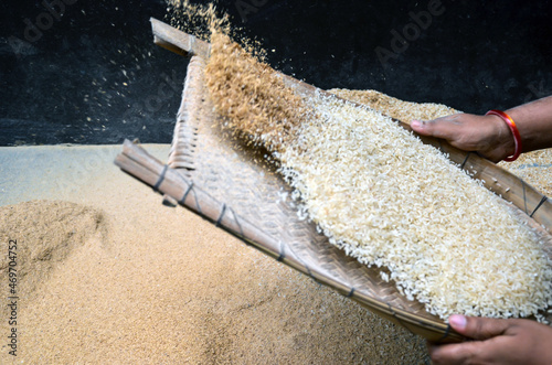 Closeup of traditional winnowing tool to separate bran or husk from the paddy, rice or seeds or other harvest. Traditional way of winnowing in Bangladesh. photo