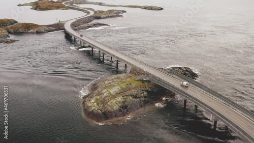 Multiple Vehicles Crossing The Magnificent Atlantic Ocean Road on A Misty Day in More and Romsdal, Norway. - Aerial  photo