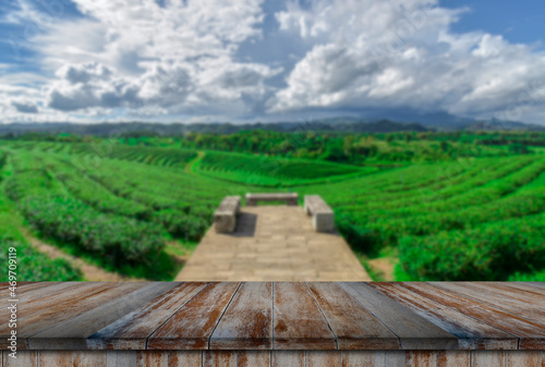 Empty wooden floor with blurred tea plantations Can be used for product display editing.