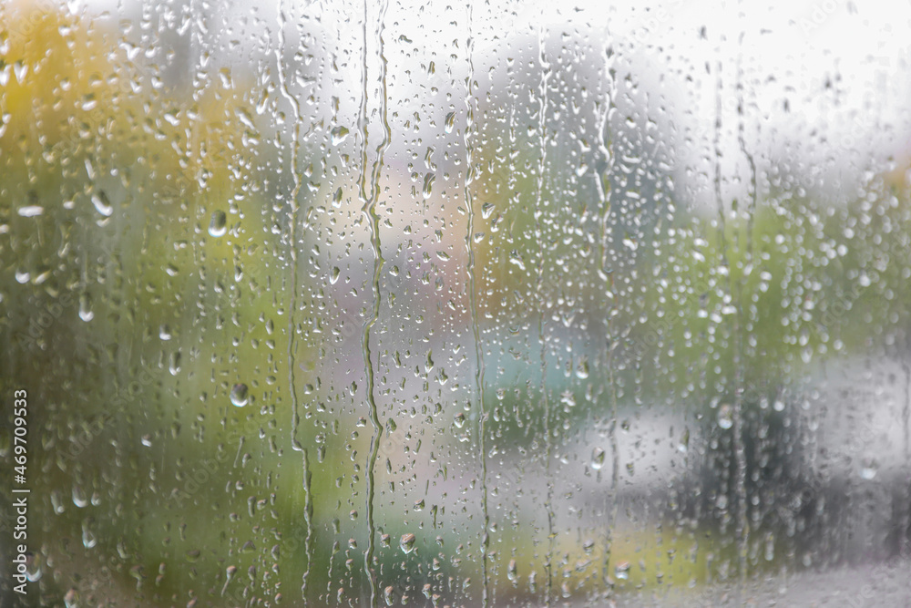 Window glass with water drops, closeup. Rainy weather