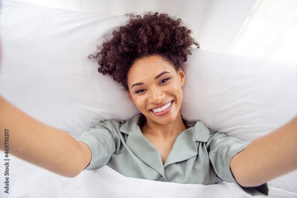 Self-portrait of attractive cheerful healthy wavy-haired girl lying in bed good mood waking up at light home house indoors Self-portrait of attractive cheerful healthy wavy-haired girl lying in bed good mood waking up at light home house indoors