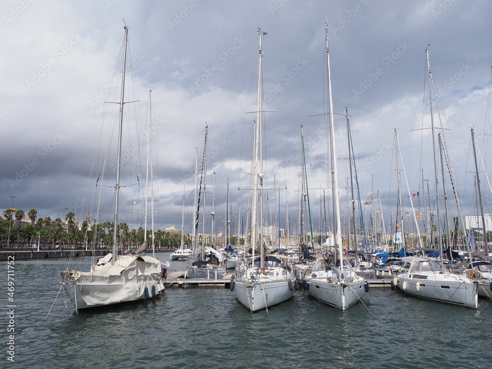 Luxury yachts and boats in port at city of Barcelona in Spain