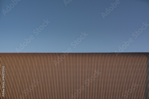 Tinplate and metal architectural wall of the building against the sky