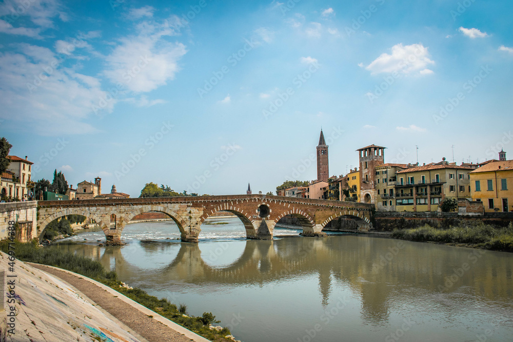 Verona, Italy, August 2017, bridge over the river, reflection in the water, embankment of the river