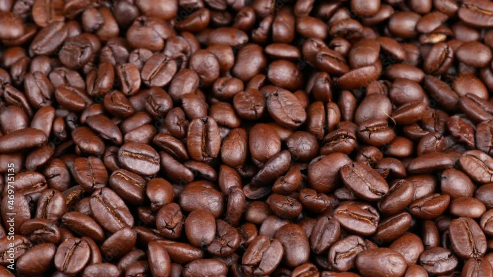 Roasted coffee beans spinning, top view. Coffee close up Roasted coffee beans spinning, top view. Coffee close up