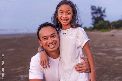 holidays, children and family concept -asian outdoor portrait of dad with his teen daughter