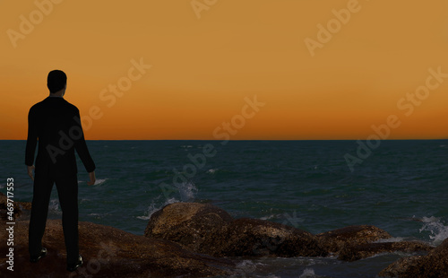 Young businessman standing on beach and thinking about his future. Silhouette of business man looking at sunset on beach. Conceptual scene.