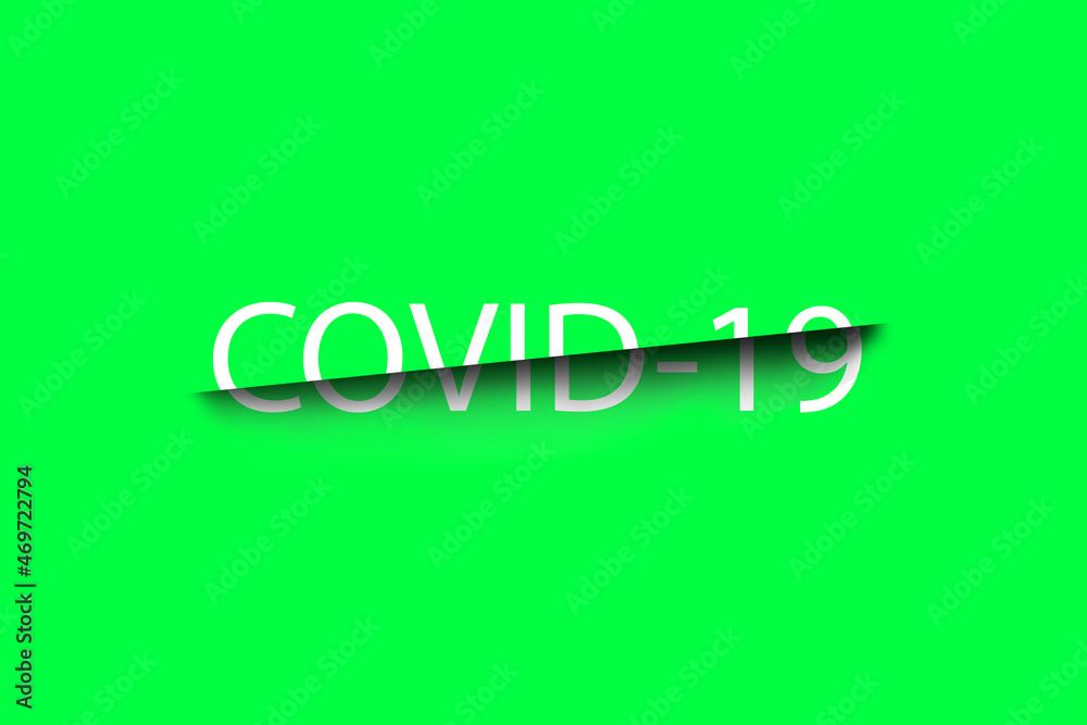 White lettering Covid-19 with a black cut on a green background close-up