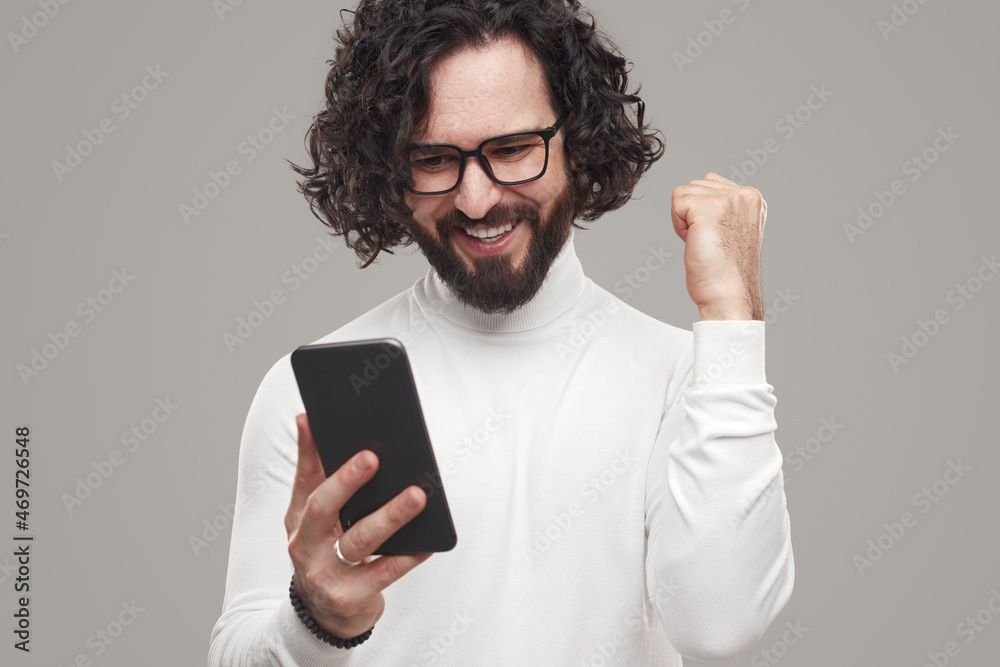Man rejoicing at good news and celebrating victory