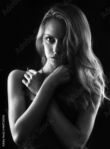 contrasting black and white portrait of a hot girl with long hair, in a low key 