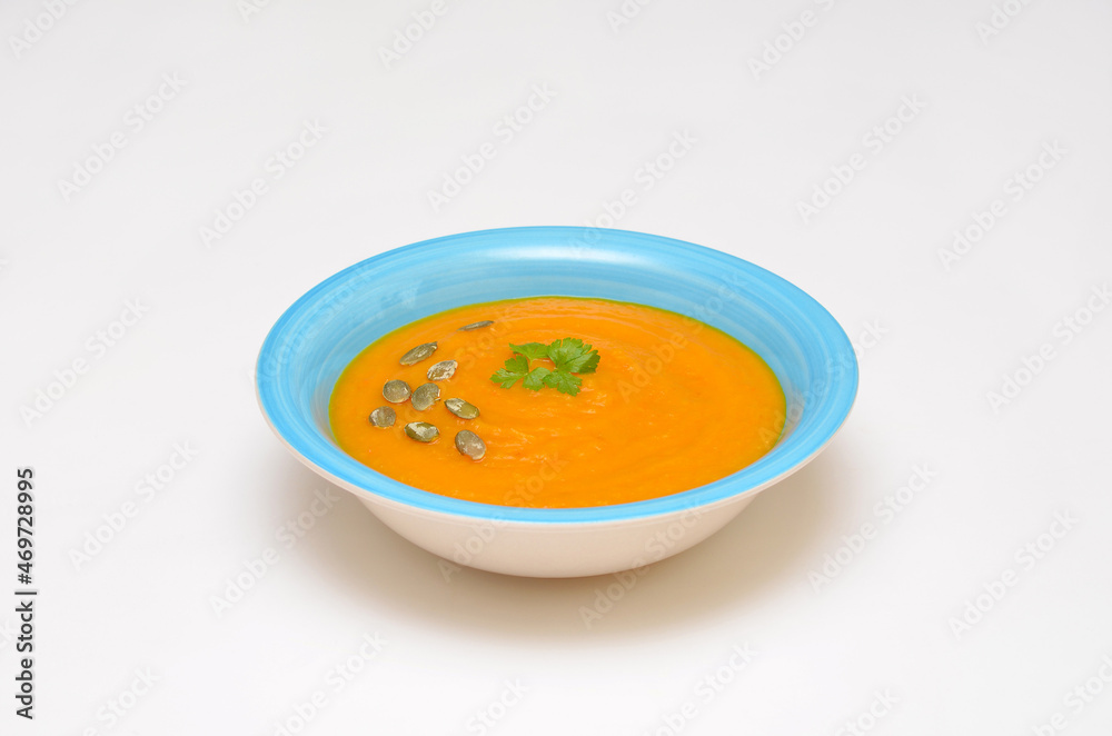 pumpkin soup in a bowl on a white background pumpkin soup in a bowl on a white background