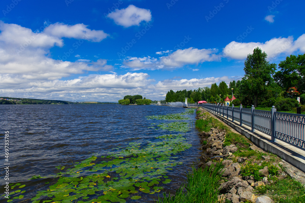 ordinary outskirts waterfront area for rest and walking near natural water reservoir in clear morning spring time, landscape design place, focus on stone along shore