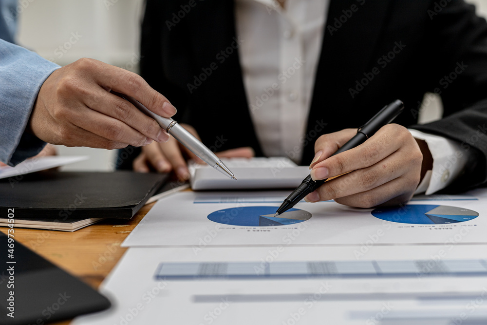 The sales department is having a monthly summary meeting to bring it to the department manager, they are verifying the correctness of the documents that are prepared before bringing in to the manager The sales department is having a monthly summary meeting to bring it to the department manager, they are verifying the correctness of the documents that are prepared before bringing in to the manager