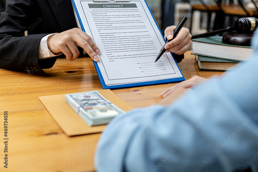 Two people are doing corrupt behavior, they are mutual business partners and are signing contracts to receive bribes for mutual benefit. The concept of business fraud and bribery is illegal. Two people are doing corrupt behavior, they are mutual business partners and are signing contracts to receive bribes for mutual benefit. The concept of business fraud and bribery is illegal.