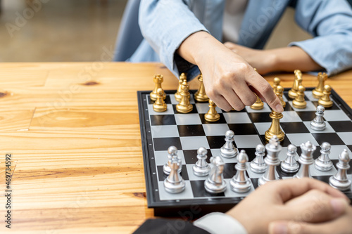 Two people playing a game of chess, concept image of two businessmen playing chess compared to a business competition that requires strategic planning and risk-based business management.