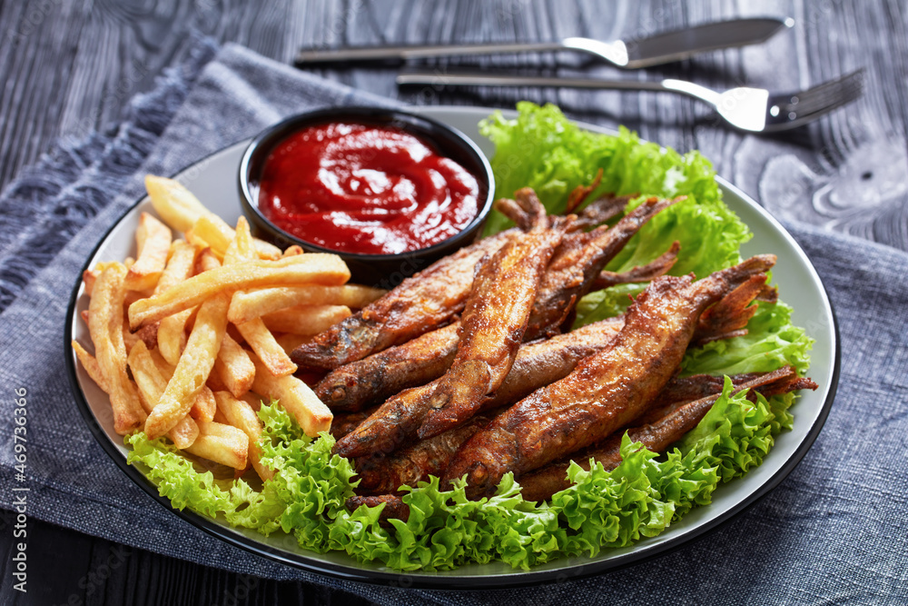 crispy fried capelin with lettuce, french fries crispy fried capelin with lettuce, french fries