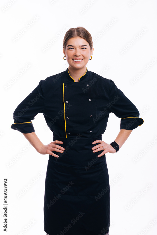 Portrait of beautiful woman, chef posing with hands on waist over white background Portrait of beautiful woman, chef posing with hands on waist over white background