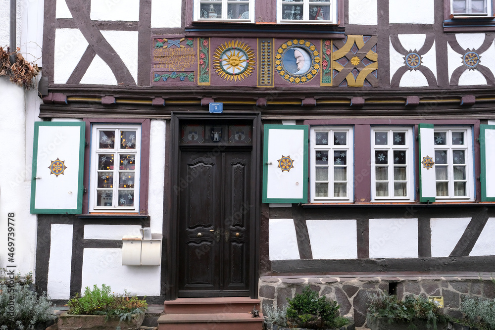 European medieval architecture of modern city in half-timbered style, cars driving on road in city center, concept of cultural tourism, travel, excursions in old town