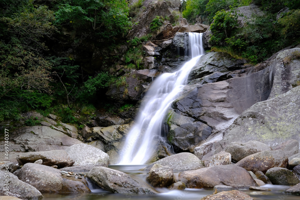 Fototapeta premium Small waterfall on an Italian stream, surrounded by nature