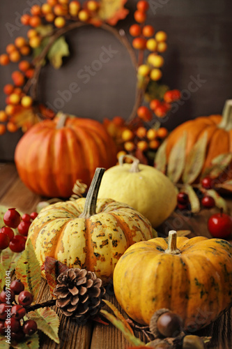 autumn background with pumpkins and colorful leaves on wooden background. Halloween or Thanksgiving Day design