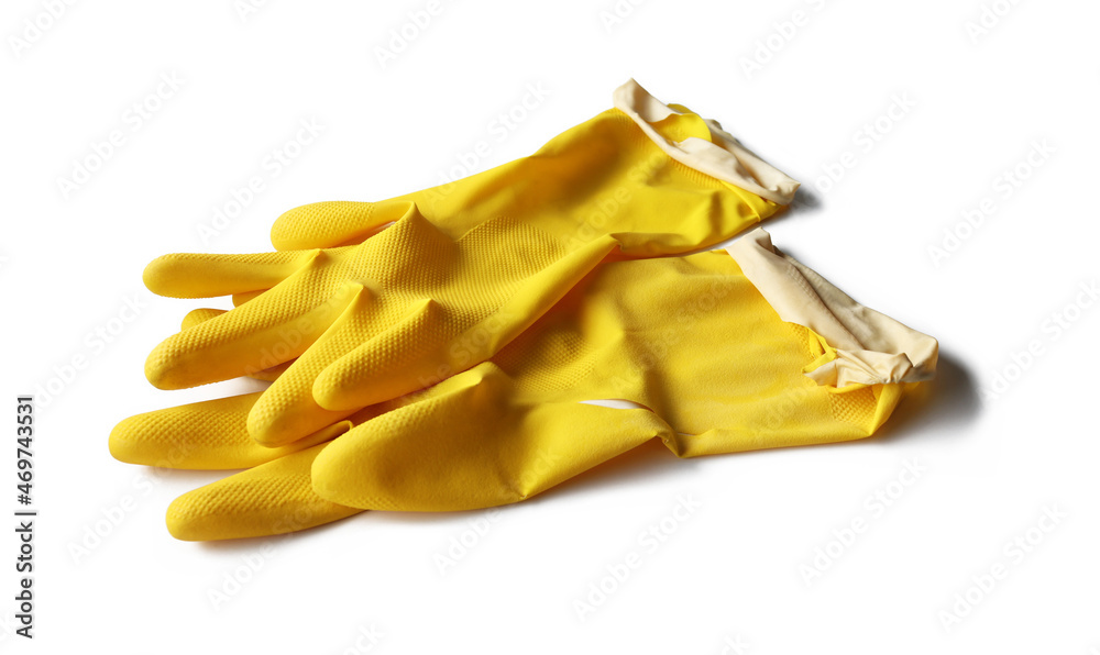 An old pair of yellow rubber gloves torn and damaged was placed on a white background. Isolated. An old pair of yellow rubber gloves torn and damaged was placed on a white background. Isolated.