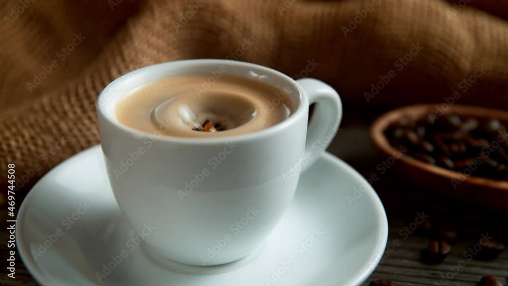Super Slow Motion Shot of Coffee Drop Falling into Cup of Espresso at 1000 fps. Super Slow Motion Shot of Coffee Drop Falling into Cup of Espresso at 1000 fps.