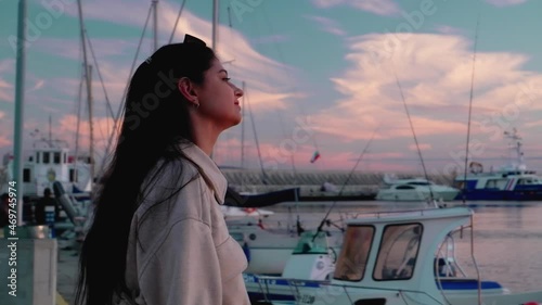 Girl in the evening against the background of a large number of yachts and boats