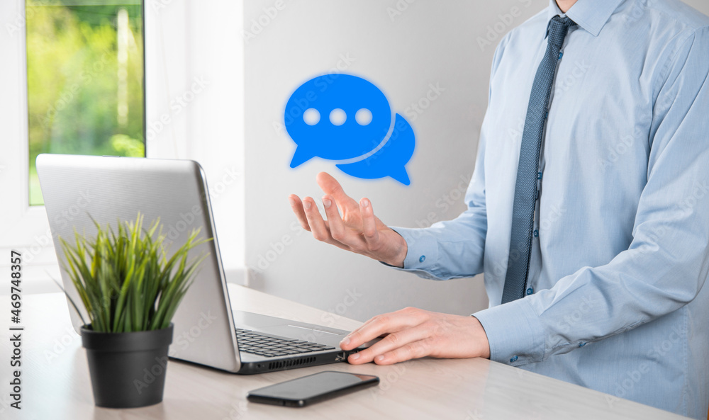 Businessman holding a message icon, bubble talk notification sign in his hands. Chat icon, sms icon, comments icon, speech bubbles Businessman holding a message icon, bubble talk notification sign in his hands. Chat icon, sms icon, comments icon, speech bubbles