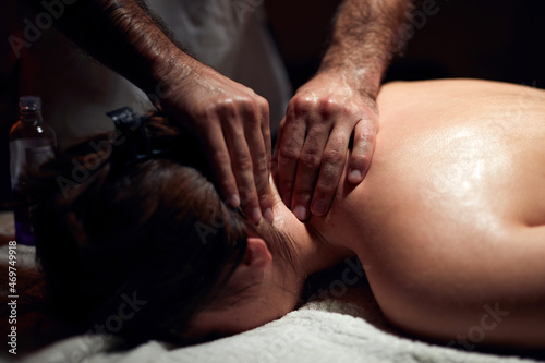 Woman on a massaging  chiropracting table  treatment of body and skin tension.