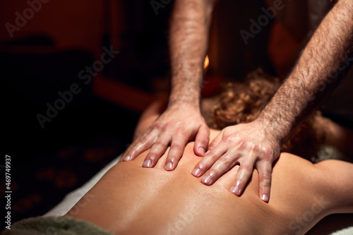 Woman on a massaging  chiropracting table  treatment of body and skin tension.