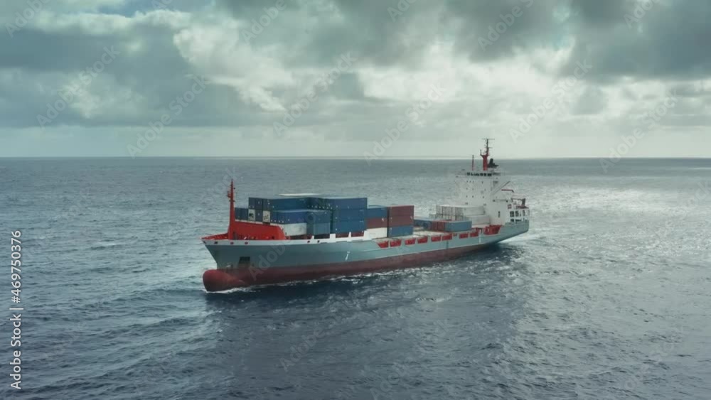 Cargo ship with colored containers on the high seas Cargo ship with colored containers on the high seas