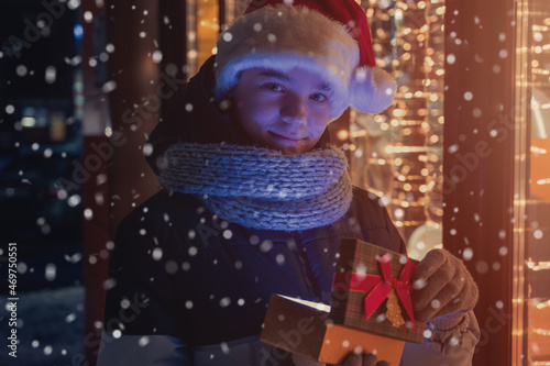 Boy in Santas hat with gift...