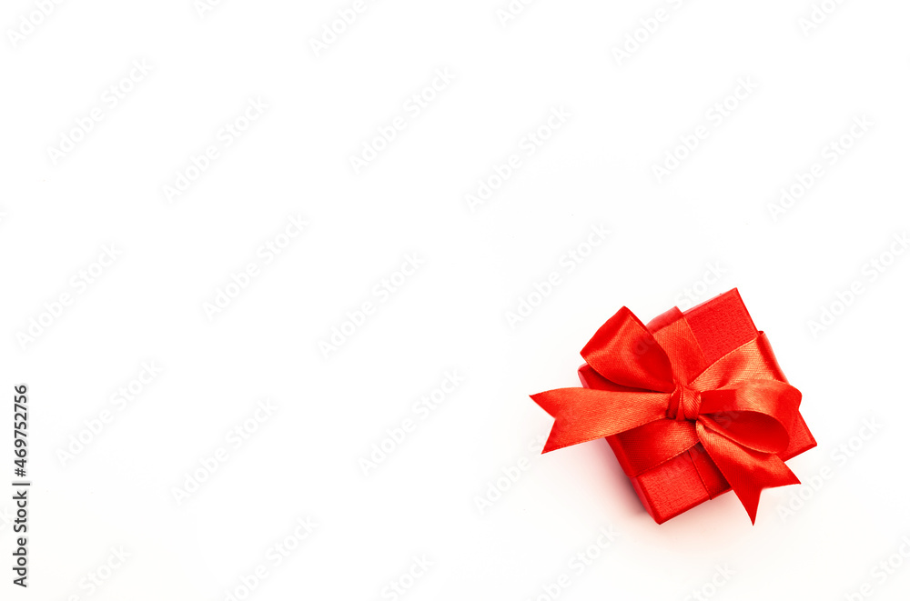 White background with red gift box, ribbons, bows. Preparation for holidays. Christmas, Valentines day, birthday, New Year concept. Top view White background with red gift box, ribbons, bows. Preparation for holidays. Christmas, Valentines day, birthday, New Year concept. Top view