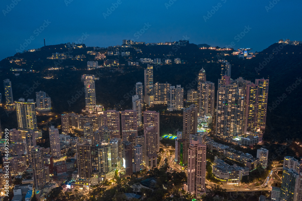 Aerial shot a Hong Kong cityscape with skyscapers at night time.