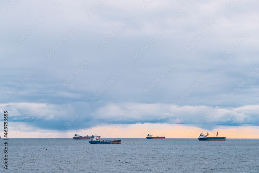 Four merchant ships on calm waters at sea