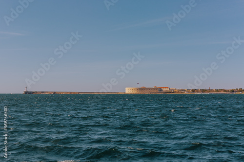 Konstantinovskaya battery, and a pier with a lighthouse at the exit from Sevastopol Bay in the Black sea © Ann